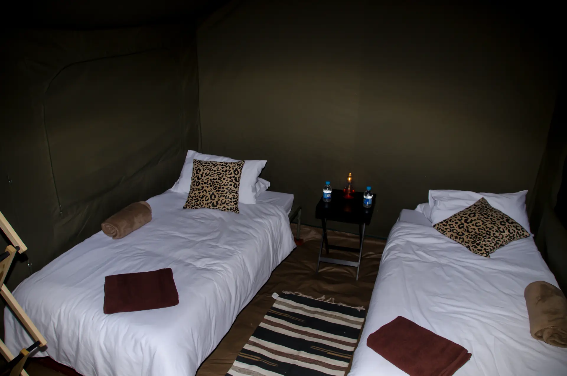 Inside a Rush Adventures lux glamping tent with two made-up beds